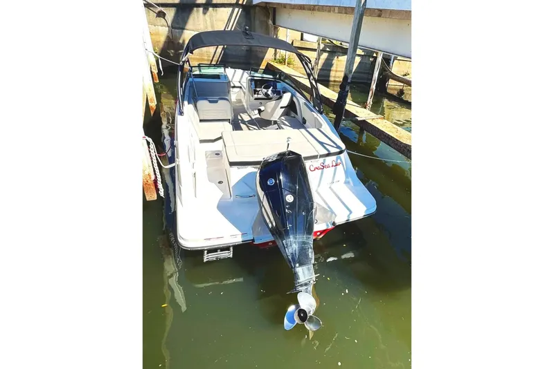 Slide: The Image of 2021 Sea Ray SPX 230 Outboard boat docked, featuring sleek design and spacious seating. - 3