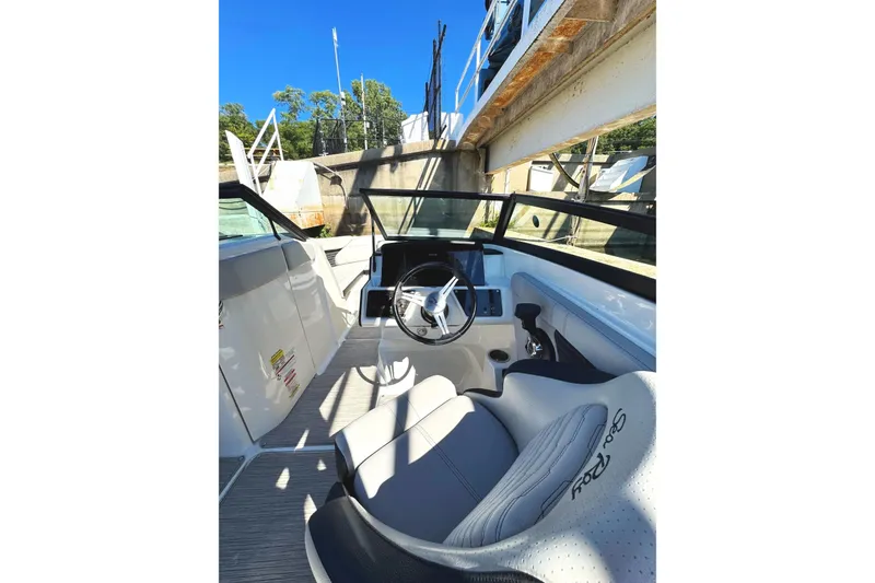 Slide: The Image of 2021 Sea Ray SPX 230 Outboard boat interior with steering wheel and seating. - 4
