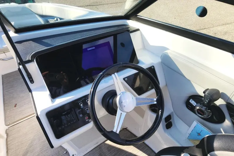 Slide: The Image of 2021 Sea Ray SPX 230 Outboard boat dashboard with steering wheel and controls. - 6