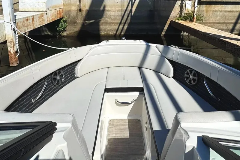 Slide: The Image of 2021 Sea Ray SPX 230 Outboard boat interior with cushioned seating and sleek design. - 8