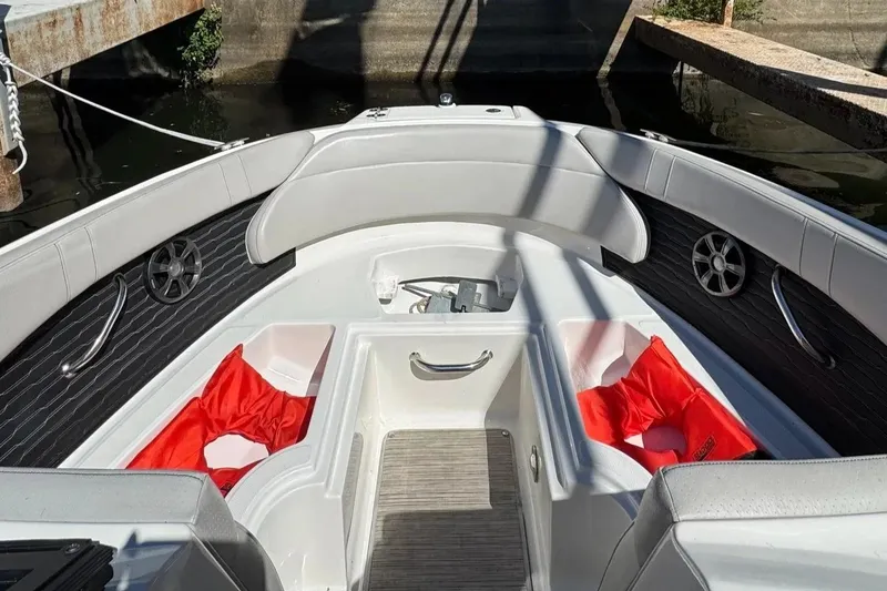 Slide: The Image of 2021 Sea Ray SPX 230 Outboard boat interior with seating and storage compartments. - 9