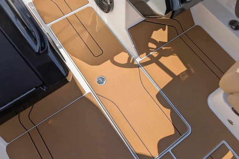 Slide: The Image of 2026 Bayliner V20 boat interior with tan flooring and sleek design. - 11