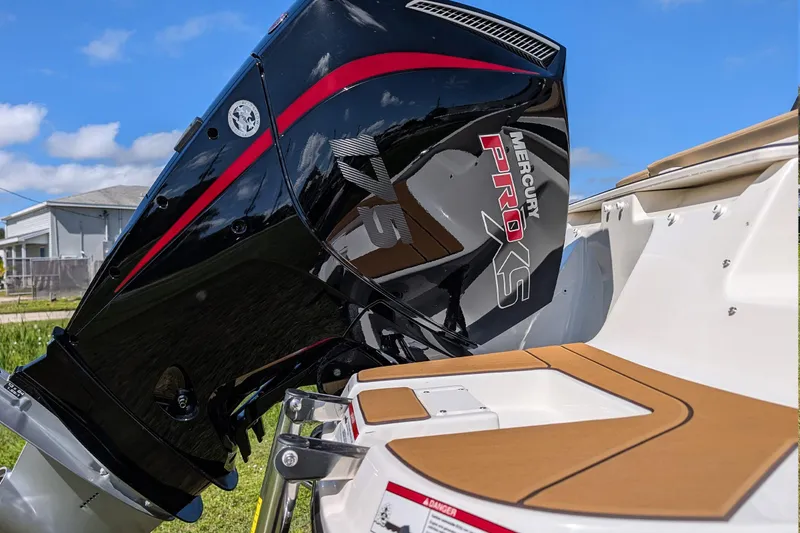 Slide: The Image of 2026 Bayliner V20 with Mercury Pro XS outboard motor, docked under blue sky. - 4