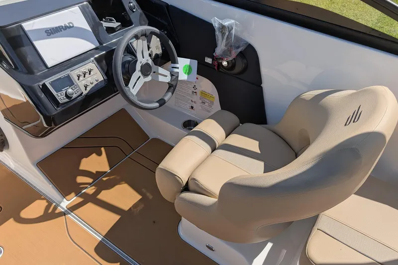 Slide: The Image of 2026 Bayliner V20 boat interior with steering wheel and beige captain's chair. - 6