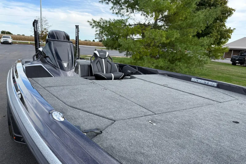 Slide: The Image of 2026 Skeeter ZXE21 boat with spacious deck and sleek design, parked outdoors. - 10