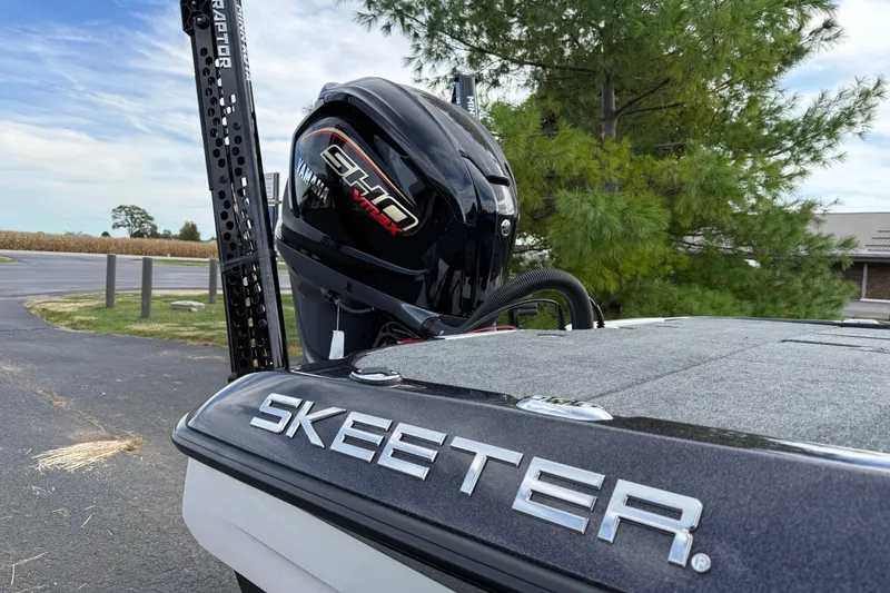 Slide: The Image of 2026 Skeeter ZXE21 boat with Yamaha SHO VMAX engine, parked outdoors. - 13