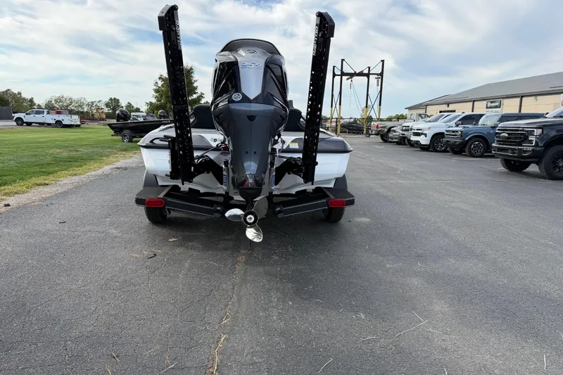 Slide: The Image of 2026 Skeeter ZXE21 boat on trailer, parked in lot with trucks and clear sky. - 4