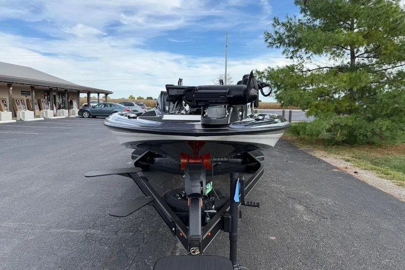 Slide: The Image of 2026 Skeeter ZXE21 boat on trailer in parking lot, clear sky background. - 7