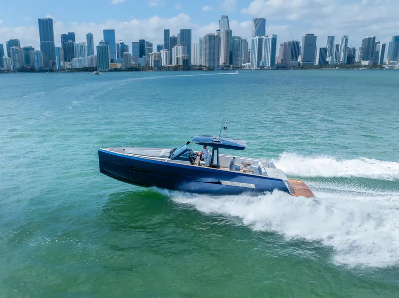 Slide: The Image of Fjord 44 Open 2022 cruising near city skyline on a sunny day. - 1