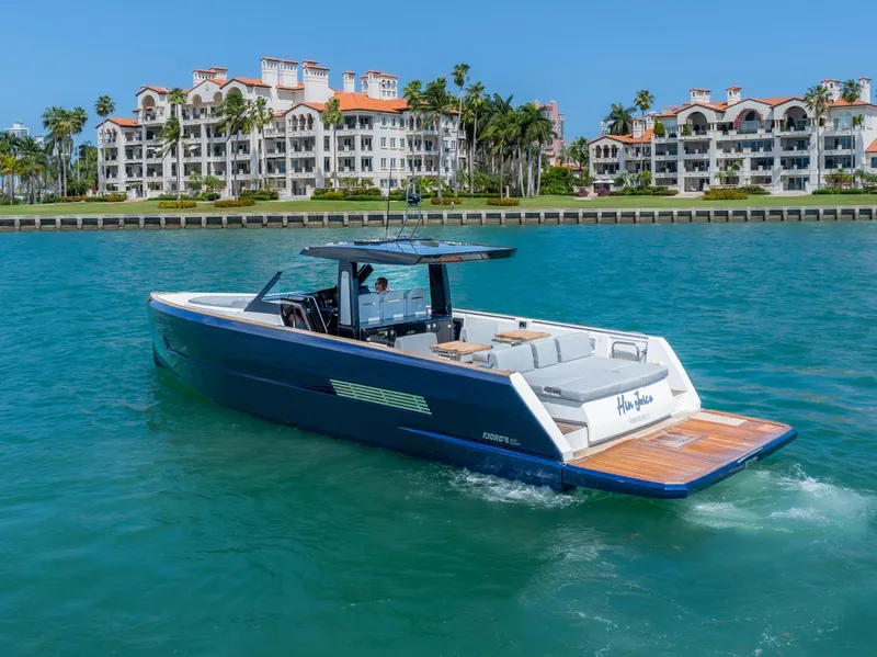 Slide: The Image of 2022 Fjord 44 Open yacht cruising near luxury waterfront residences. - 11