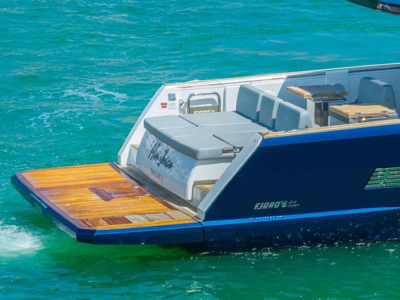 Slide: The Image of Fjord 44 Open 2022 yacht on turquoise water, featuring sleek design and spacious deck. - 13