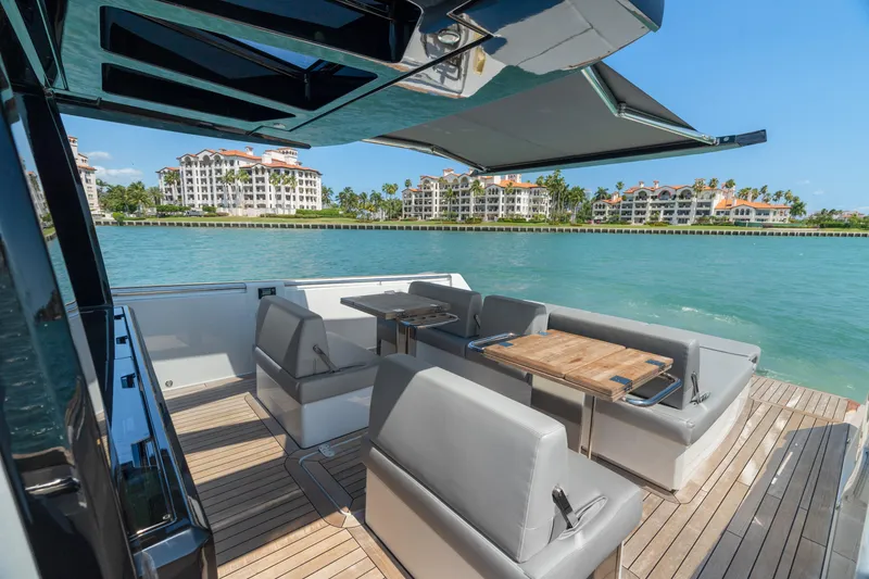 Slide: The Image of Luxurious 2022 Fjord 44 Open yacht with elegant seating, docked near waterfront condos. - 22