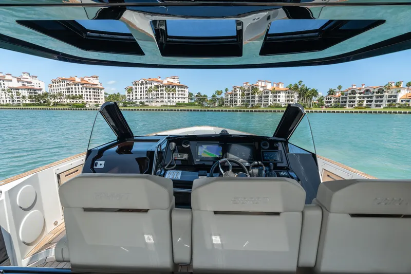 Slide: The Image of 2022 Fjord 44 Open yacht cockpit with modern controls, overlooking waterfront buildings. - 26