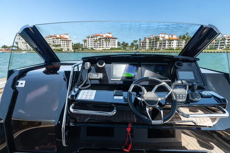 Slide: The Image of Cockpit view of 2022 Fjord 44 Open yacht with waterfront buildings in the background. - 27