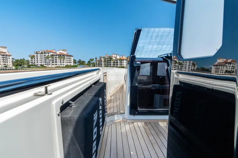 Slide: The Image of 2022 Fjord 44 Open yacht with sleek deck and modern design, docked near luxury buildings. - 29