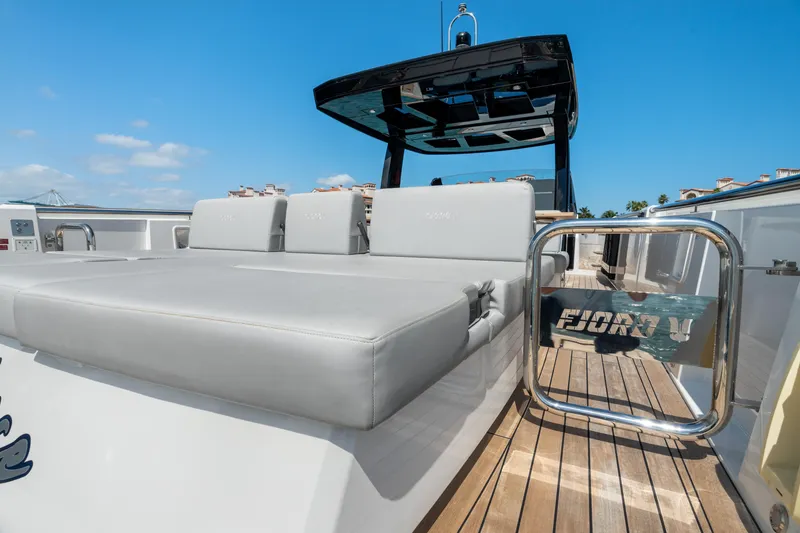 Slide: The Image of 2022 Fjord 44 Open yacht with sleek deck and luxurious seating under clear blue sky. - 33