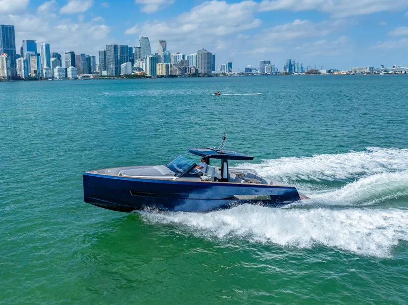 Slide: The Image of 2022 Fjord 44 Open yacht cruising in a city harbor with skyline backdrop. - 5