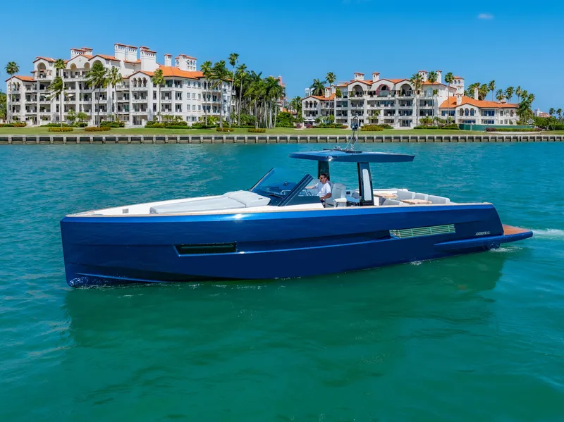 Slide: The Image of 2022 Fjord 44 Open yacht cruising near luxury waterfront residences. - 9