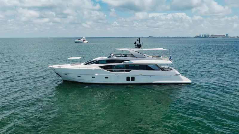 Slide: The Image of 2022 Sanlorenzo SL86 yacht cruising on open water under a partly cloudy sky. - 17