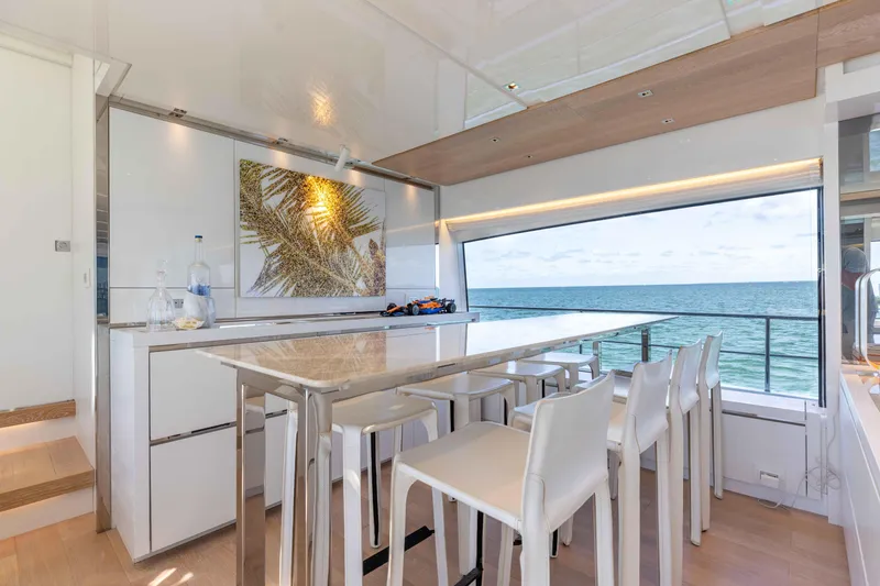 Slide: The Image of Luxurious Sanlorenzo SL86 yacht interior with ocean view, modern dining area, and elegant decor. - 37