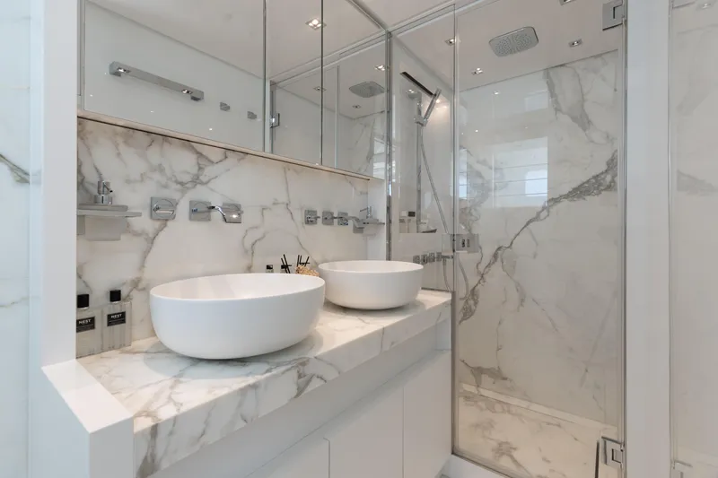 Slide: The Image of Luxurious marble bathroom with dual sinks and glass shower in 2022 Sanlorenzo SL86 yacht. - 48