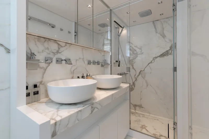 Slide: The Image of Luxurious marble bathroom with dual sinks and glass shower in 2022 Sanlorenzo SL86 yacht. - 49