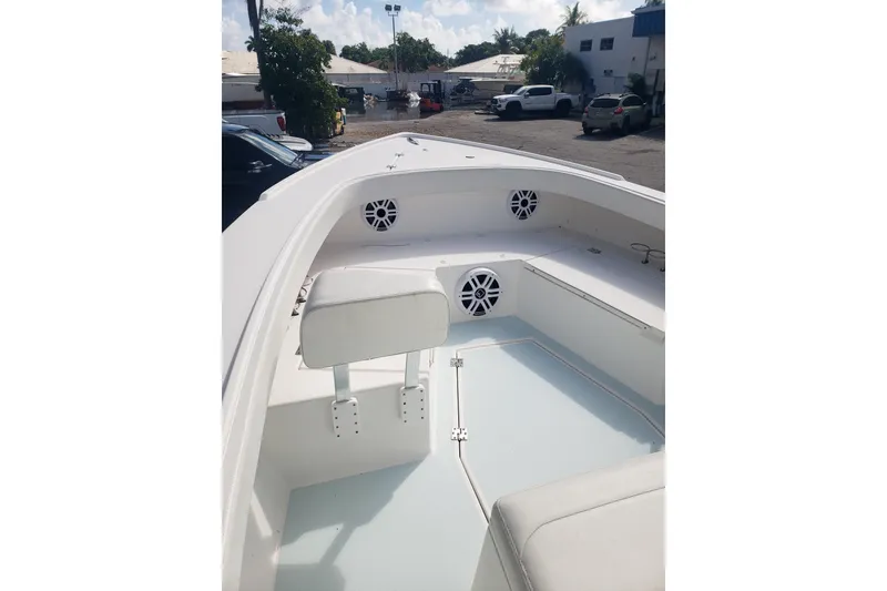 Slide: The Image of 2022 Albury Brothers 27 boat interior with seating and speakers in a parking lot. - 20