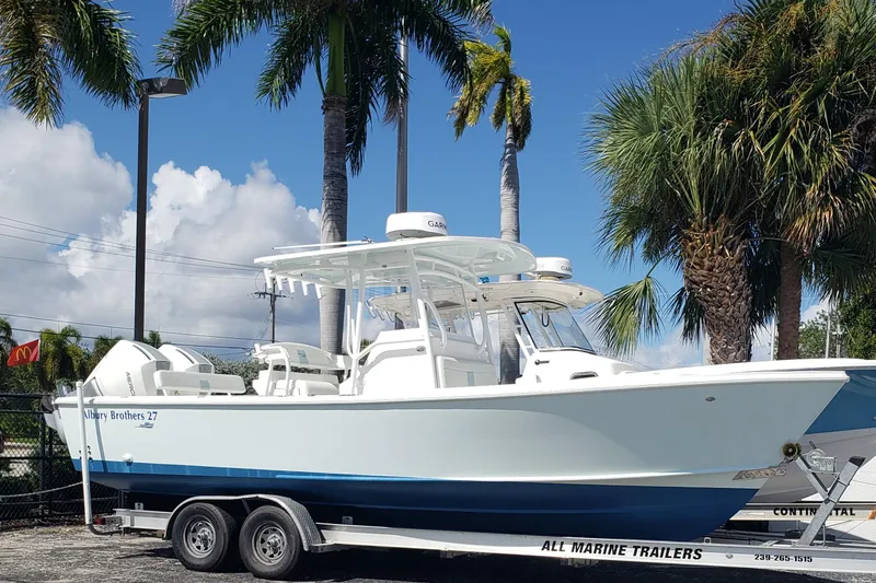 Slide: The Image of 2022 Albury Brothers 27 boat on trailer, surrounded by palm trees. - 3
