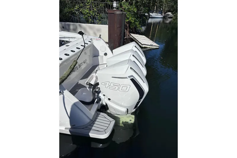 Slide: The Image of 2020 Intrepid 409 Valor with triple 450 engines docked in a serene waterway. - 17