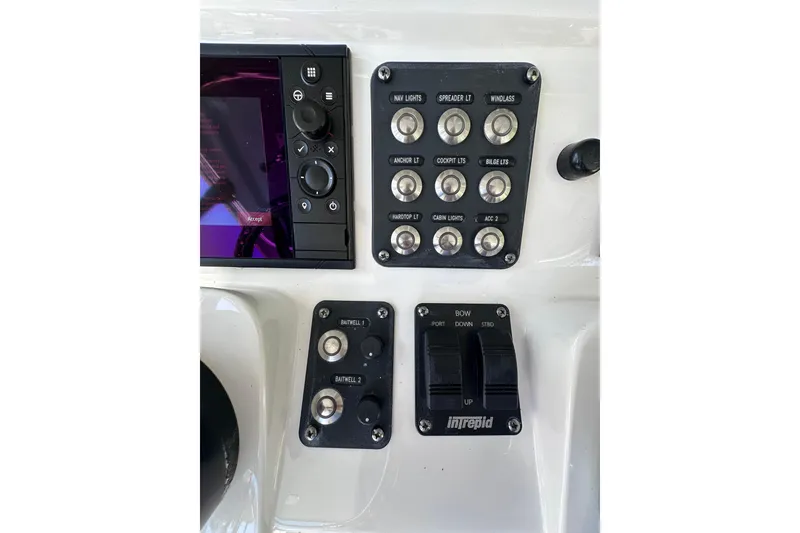 Slide: The Image of Control panel of a 2020 Intrepid 409 Valor boat with various switches and buttons. - 22