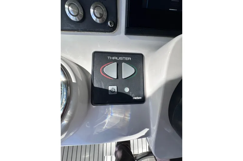 Slide: The Image of Control panel of a 2020 Intrepid 409 Valor boat featuring a thruster button. - 23