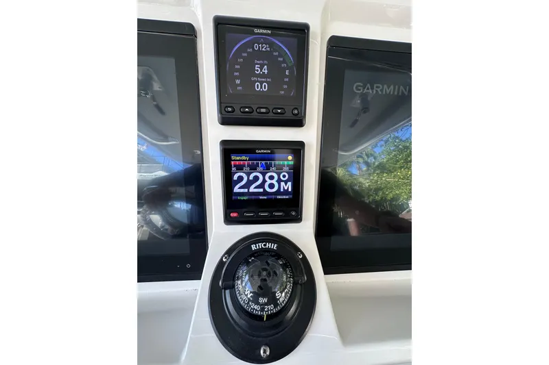 Slide: The Image of Intrepid 409 Valor 2020 boat dashboard with Garmin displays and Ritchie compass. - 24