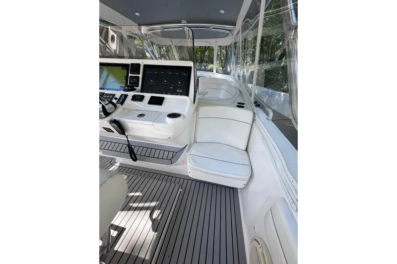 Slide: The Image of 2020 Intrepid 409 Valor boat interior with modern dashboard and seating. - 28