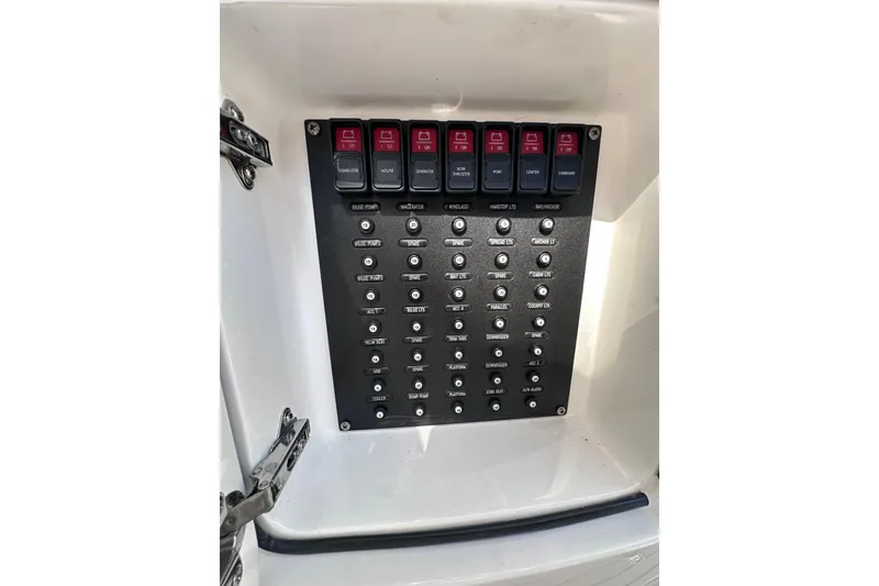 Slide: The Image of Control panel of a 2020 Intrepid 409 Valor boat with labeled switches and buttons. - 34