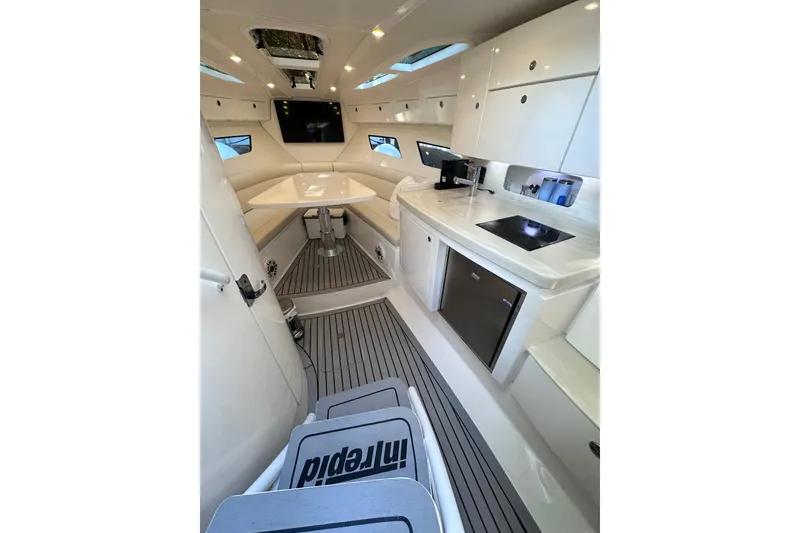 Slide: The Image of Interior of 2020 Intrepid 409 Valor boat with modern kitchen and seating area. - 37