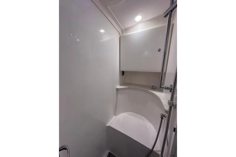 Slide: The Image of 2020 Intrepid 409 Valor boat interior shower with sleek, modern design and chrome fixtures. - 43