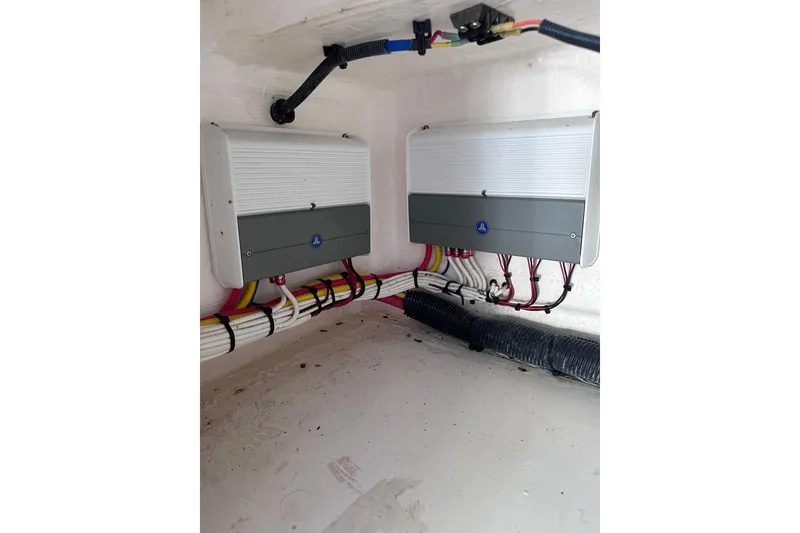 Slide: The Image of Electrical components inside a 2020 Intrepid 409 Valor boat, featuring organized wiring and connectors. - 56