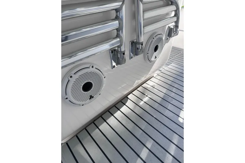 Slide: The Image of 2020 Intrepid 409 Valor boat deck with speakers and metal railings. - 57