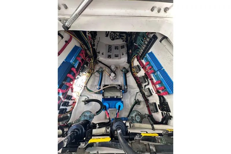 Slide: The Image of Engine compartment of a 2020 Intrepid 409 Valor boat, showcasing wiring and components. - 64