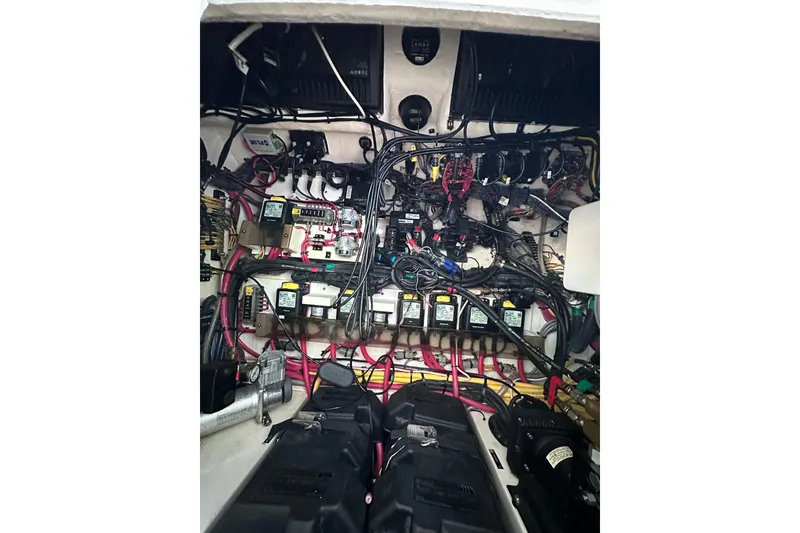 Slide: The Image of Engine compartment of a 2020 Intrepid 409 Valor boat, showcasing complex wiring and components. - 65