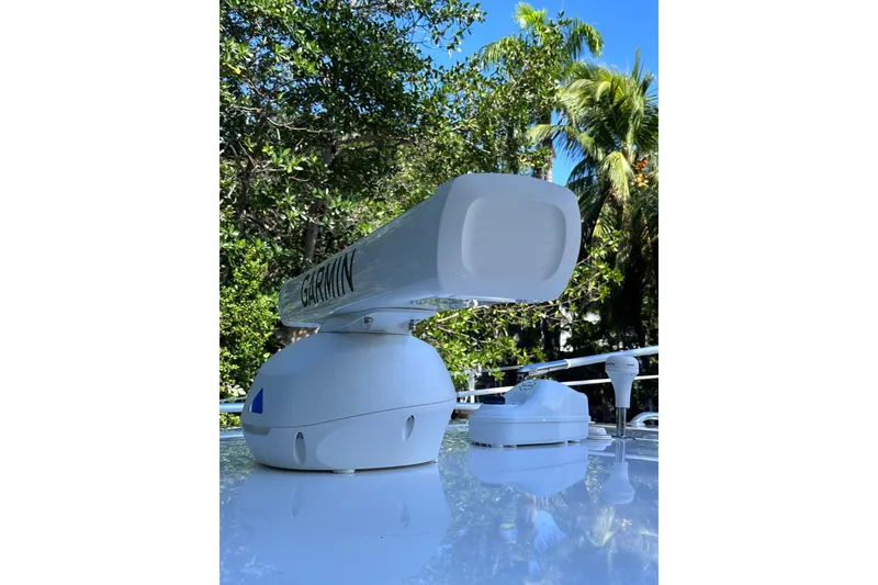 Slide: The Image of Garmin radar on 2020 Intrepid 409 Valor boat, surrounded by lush greenery. - 69