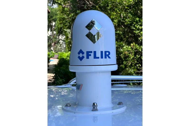 Slide: The Image of FLIR camera mounted on 2020 Intrepid 409 Valor boat, surrounded by greenery. - 70