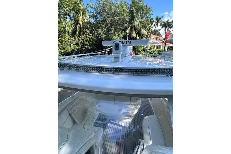 Slide: The Image of 2020 Intrepid 409 Valor boat with Garmin radar, surrounded by lush greenery. - 71