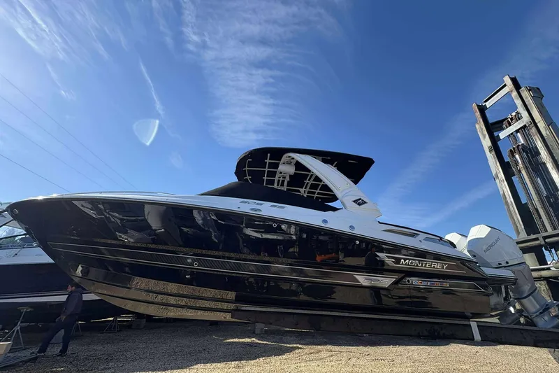The Image of 2023 Monterey 305SS Super Sport boat displayed outdoors under a clear blue sky. - 1