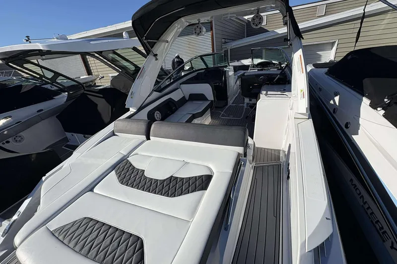 Slide: The Image of 2023 Monterey 305SS Super Sport boat with luxurious seating and sleek design. - 10