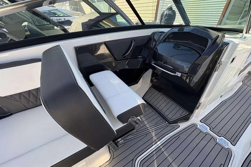 Slide: The Image of 2023 Monterey 305SS Super Sport boat interior with sleek black and white seating. - 12