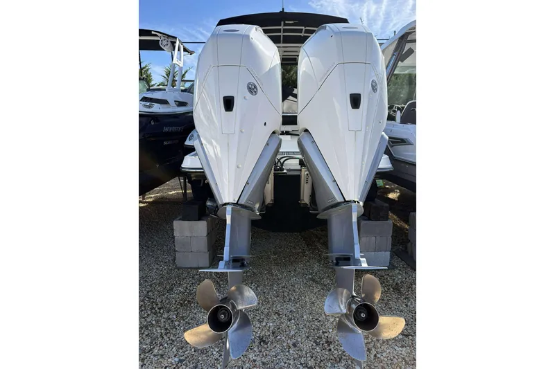 Slide: The Image of 2023 Monterey 305SS Super Sport boat with dual outboard engines on display. - 23