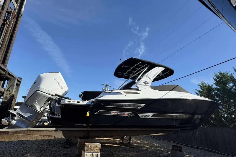 Slide: The Image of 2023 Monterey 305SS Super Sport boat with Mercury engine, displayed outdoors under clear blue sky. - 3