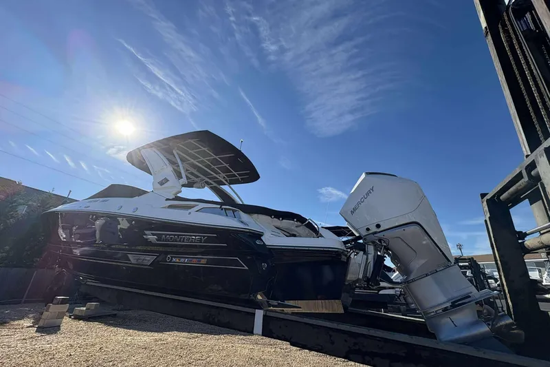 Slide: The Image of 2023 Monterey 305SS Super Sport boat with Mercury engine under clear blue sky. - 5
