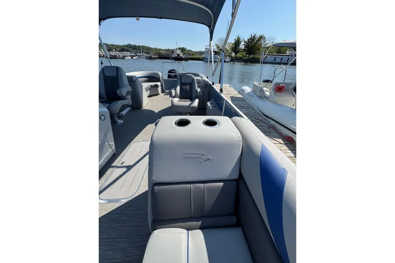 Slide: The Image of 2022 Bennington SX 23 Quad Bench pontoon boat interior at dockside. - 10